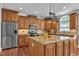 Modern kitchen with stainless steel appliances, granite countertops, and custom wood cabinets at 5521 Erinvale Ct, Holly Springs, NC 27540