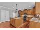 Well-appointed kitchen featuring an island, stainless steel appliances, granite counters and hardwood flooring at 5521 Erinvale Ct, Holly Springs, NC 27540