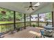 Spacious screened porch with ceiling fan, ample room for lounging, and nature views at 5521 Erinvale Ct, Holly Springs, NC 27540