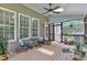 Relaxing screened-in porch with ceiling fan, skylight, and comfortable seating at 5521 Erinvale Ct, Holly Springs, NC 27540