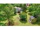 Landscaped property featuring a house, a storage shed, and a lush green lawn with mature trees at 5625 Church Rd, Graham, NC 27253
