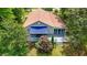 Aerial view of house with brown roof, large back deck with awning, and mature landscaped yard at 5625 Church Rd, Graham, NC 27253