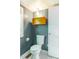 Compact bathroom featuring a toilet, floating storage and silver and grey walls at 5625 Church Rd, Graham, NC 27253