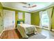 This bedroom features hardwood floors, a window, and stylish green walls at 5625 Church Rd, Graham, NC 27253