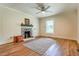 Bedroom with wood floors, neutral walls, stylish fireplace, and great natural light at 5625 Church Rd, Graham, NC 27253