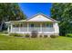 Charming single-story home with a inviting front porch, landscaped yard, and lots of shade trees at 5625 Church Rd, Graham, NC 27253