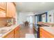 Well-designed kitchen area with wooden cabinets, stainless steel appliances, and a view of the adjacent dining space at 5625 Church Rd, Graham, NC 27253