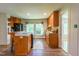 Cozy kitchen with wood cabinets, updated appliances, breakfast bar, and a sunlit window at 5625 Church Rd, Graham, NC 27253