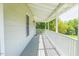 Covered front porch featuring classic railing and ceiling fans creating an ideal outdoor space at 5625 Church Rd, Graham, NC 27253