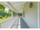 Inviting covered front porch featuring classic white railing and exterior lighting at 5625 Church Rd, Graham, NC 27253