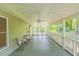 Spacious screened porch with classic white railing, ceiling fans, and outdoor seating at 5625 Church Rd, Graham, NC 27253