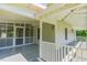 Covered screened porch featuring classic railing, ceiling fans and an ideal outdoor space at 5625 Church Rd, Graham, NC 27253