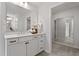 Bright bathroom featuring double sinks, white cabinets, and a well-lit mirror at 60 Bold Dr, Youngsville, NC 27596