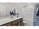 Bathroom with a white countertop vanity, shower-tub combo, and modern fixtures at 60 Bold Dr, Youngsville, NC 27596