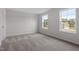 Bedroom with neutral carpet, two windows offering natural light, and a calming atmosphere at 60 Bold Dr, Youngsville, NC 27596