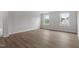 Spacious bedroom with two windows providing natural light and wood-look flooring at 60 Bold Dr, Youngsville, NC 27596
