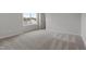 Cozy bedroom with neutral carpeting and a view of the outdoors through one window at 60 Bold Dr, Youngsville, NC 27596