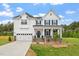 Inviting two-story home with a two-car garage, classic architectural design, and a well-manicured front yard at 60 Bold Dr, Youngsville, NC 27596