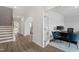 Bright hallway with hardwood floors, an archway, and a view into the office with french doors at 60 Bold Dr, Youngsville, NC 27596