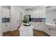 Bright kitchen featuring stainless steel appliances, white cabinets, and an island with quartz countertops at 60 Bold Dr, Youngsville, NC 27596