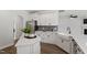 Modern kitchen featuring stainless steel appliances, white cabinets, and an island with quartz countertops at 60 Bold Dr, Youngsville, NC 27596
