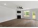 Spacious living room with a fireplace, ceiling fan, and access to the outdoor deck at 60 Bold Dr, Youngsville, NC 27596