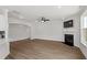 Open living room featuring a fireplace, ceiling fan, and wood-look floors for a modern aesthetic at 60 Bold Dr, Youngsville, NC 27596