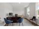 Well-lit home office featuring hardwood floors, modern furniture, and large windows for ample natural light at 60 Bold Dr, Youngsville, NC 27596