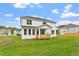 Beautifully landscaped backyard with a charming back porch, ideal for outdoor living and entertaining at 60 Bold Dr, Youngsville, NC 27596