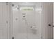 Modern shower with glass doors, a built-in shelf, and pristine white subway tile at 60 Bold Dr, Youngsville, NC 27596