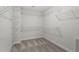 Spacious walk-in closet featuring white wire shelving and neutral carpeting at 60 Bold Dr, Youngsville, NC 27596
