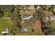 Aerial view of the property surrounded by mature trees and lush, green lawns at 620 Richardson Rd, Zebulon, NC 27597