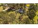 Scenic aerial view of the home nestled amongst lush, mature trees on expansive grounds at 620 Richardson Rd, Zebulon, NC 27597
