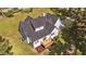 A light blue home with a dark roof has a back deck and large grassy lawn at 620 Richardson Rd, Zebulon, NC 27597