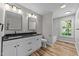 Bathroom with double vanity, modern fixtures, and a window with natural light at 620 Richardson Rd, Zebulon, NC 27597