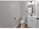 Bright half bathroom featuring a toilet, sink with vanity, and neutral color scheme at 620 Richardson Rd, Zebulon, NC 27597