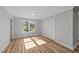 Sun-filled bedroom features wood-look flooring, neutral paint, and a closet at 620 Richardson Rd, Zebulon, NC 27597