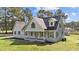 Beautiful home featuring light blue siding, black shutters and a well-manicured front lawn at 620 Richardson Rd, Zebulon, NC 27597