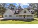 Charming two-story home with light blue siding, dark shutters and a landscaped front yard at 620 Richardson Rd, Zebulon, NC 27597