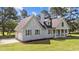 Stylish home featuring a side-entry garage, light blue siding, and a well-manicured lawn at 620 Richardson Rd, Zebulon, NC 27597