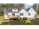 Back exterior of the home, featuring a wooden deck, lawn and lots of windows at 620 Richardson Rd, Zebulon, NC 27597