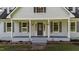 Charming front porch highlights the home's entry with elegant columns, and manicured landscaping at 620 Richardson Rd, Zebulon, NC 27597