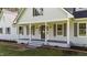 Inviting front porch with classic columns and well manicured landscaping adds curb appeal at 620 Richardson Rd, Zebulon, NC 27597