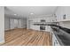Bright open floor plan featuring stainless appliances, granite countertops and wood-look floors at 620 Richardson Rd, Zebulon, NC 27597