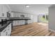 Open kitchen features granite countertops, white cabinets and stainless appliances at 620 Richardson Rd, Zebulon, NC 27597