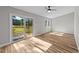 Living room showcasing wood floors, natural light, sliding glass doors and a ceiling fan at 620 Richardson Rd, Zebulon, NC 27597