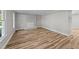 Cozy living room featuring a brick fireplace, neutral walls and wood-look floors at 620 Richardson Rd, Zebulon, NC 27597