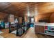 Finished attic space with wood floors, ceiling, exposed brick, and cozy seating area at 6447 Beulah Church Rd, Liberty, NC 27298