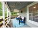 Cozy back porch with comfortable chairs and a bright blue area rug. Perfect for relaxing at 6447 Beulah Church Rd, Liberty, NC 27298