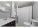 Cozy gray bathroom featuring a modern sink and shower with gray tiled floors at 6447 Beulah Church Rd, Liberty, NC 27298